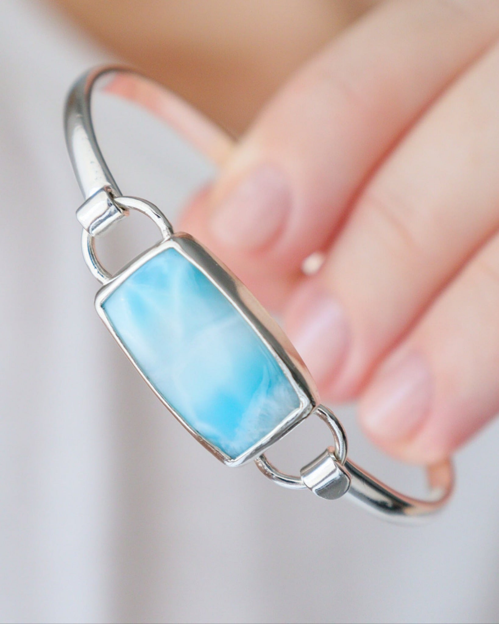 Mano sostiene pulsera Eunoia con Larimar.